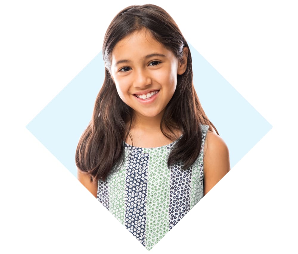 A young girl is smiling.