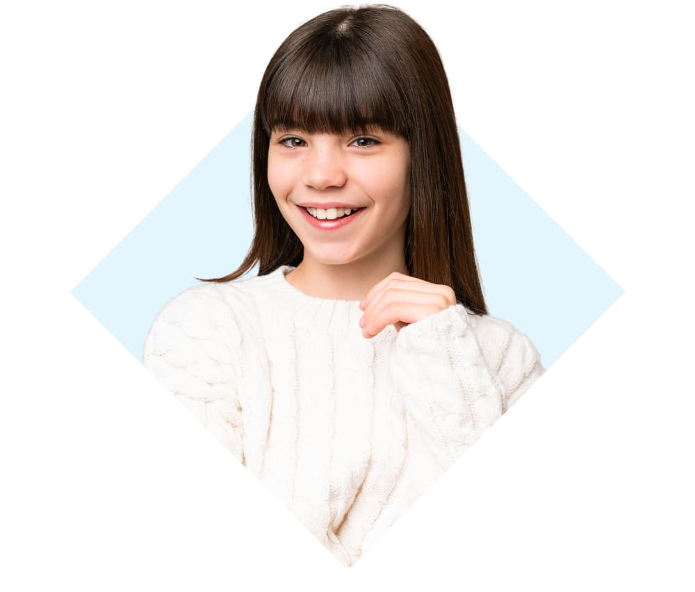 Smiling girl of about 11 wearing a comfy looking cable knit sweater.